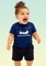A toddler wearing a navy blue baby t-shirt with white Chinook helicopter, ROYAL AIR FORCE text, and Ursa Major star constellation above the design.