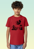 A boy wearing a red heavyweight organic cotton t-shirt with black print of a Chinook helicopter flying over London landmarks including Big Ben, Tower of London, and a double decker bus.