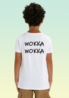 The back of a boy wearing a white t-shirt with bold black print reading “WOKKA WOKKA” across the upper back.