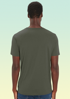 The back view of a man wearing a khaki t-shirt, plain with no design.