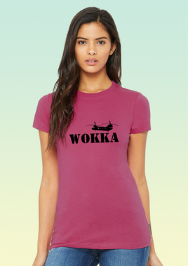 A woman wearing a bright pink organic cotton women’s t-shirt with black Chinook design above large text that reads WOKKA.