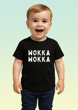 A little boy wearing a black cotton baby t-shirt with bold white WOKKA WOKKA text across the chest.