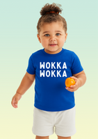 A little girl wearing a royal blue baby t-shirt with bold white WOKKA WOKKA text across the chest.