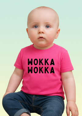 A baby wearing a pink cotton baby t-shirt with bold black WOKKA WOKKA text across the chest.