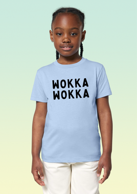 A girl wearing a sky blue cotton t-shirt with the text WOKKA WOKKA in bold black print across the front.