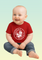 A baby wearing a red t-shirt with white circular Chinook helicopter graphic and WOKKA WOKKA text around the design.