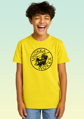 A boy wearing a yellow cotton children’s t-shirt featuring a stylised black Chinook helicopter in a circular front design.